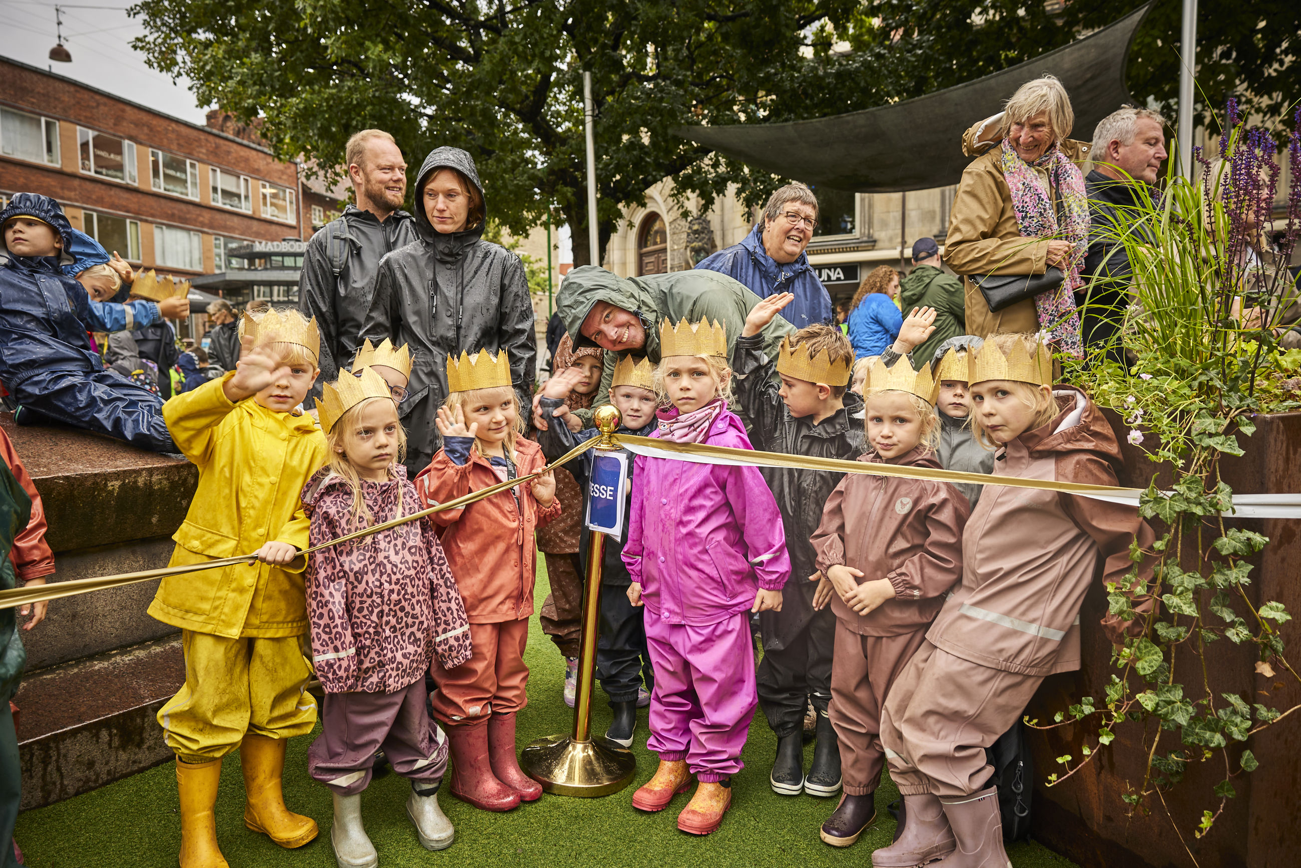 Børn med kroner på står klar til at modtage Dronningen på Rådhustorvet